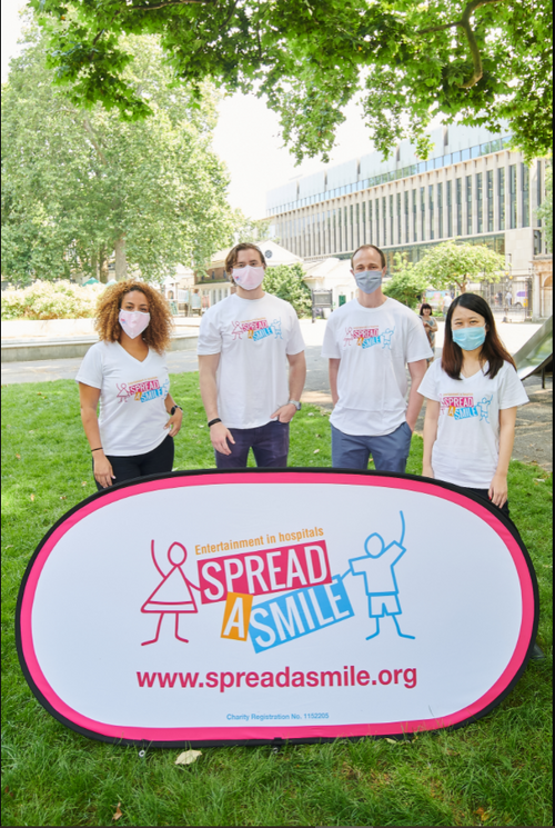 volunteers posing with spread a smile sign