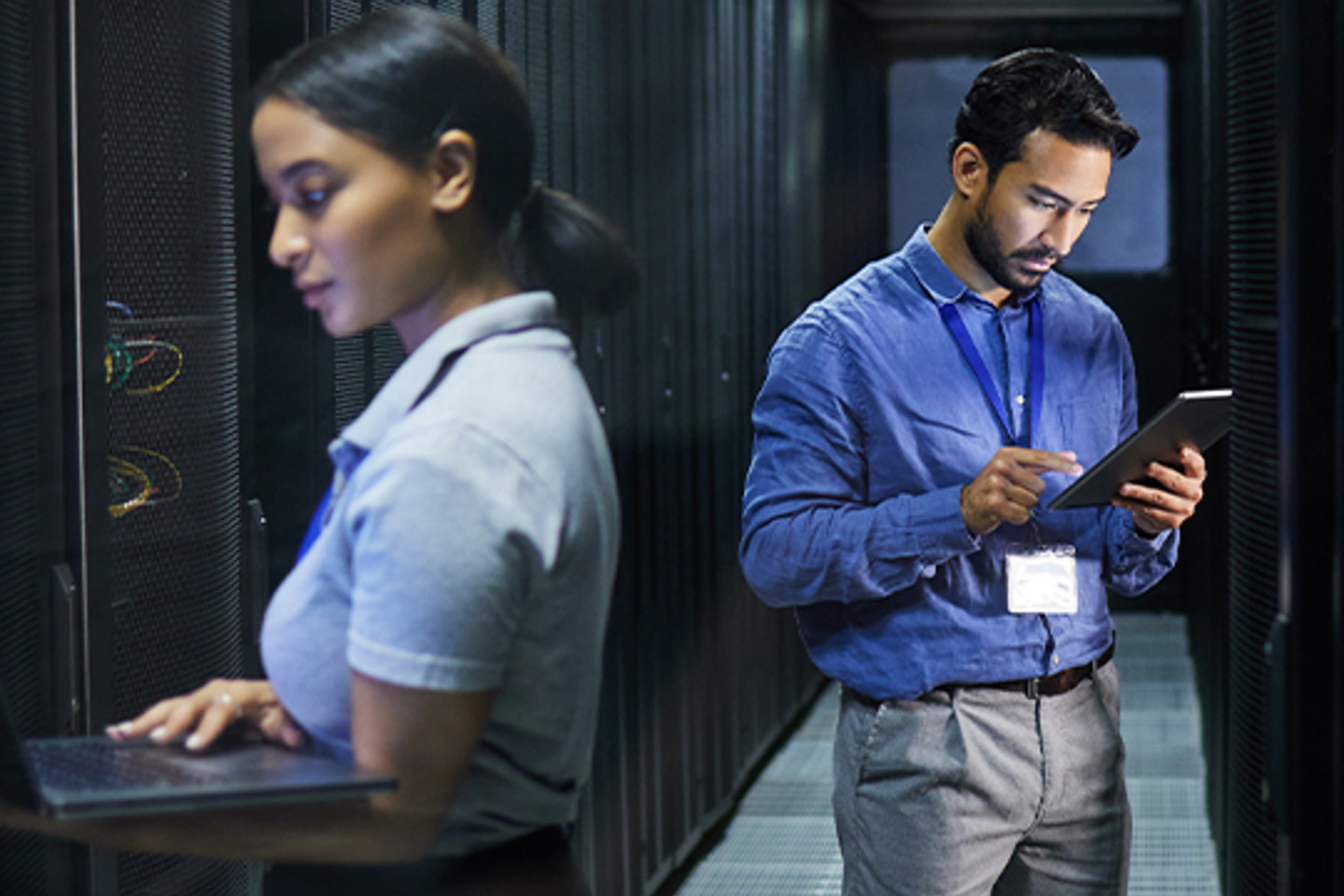 Teamwork Com Portrait 2 two people working in a hallway